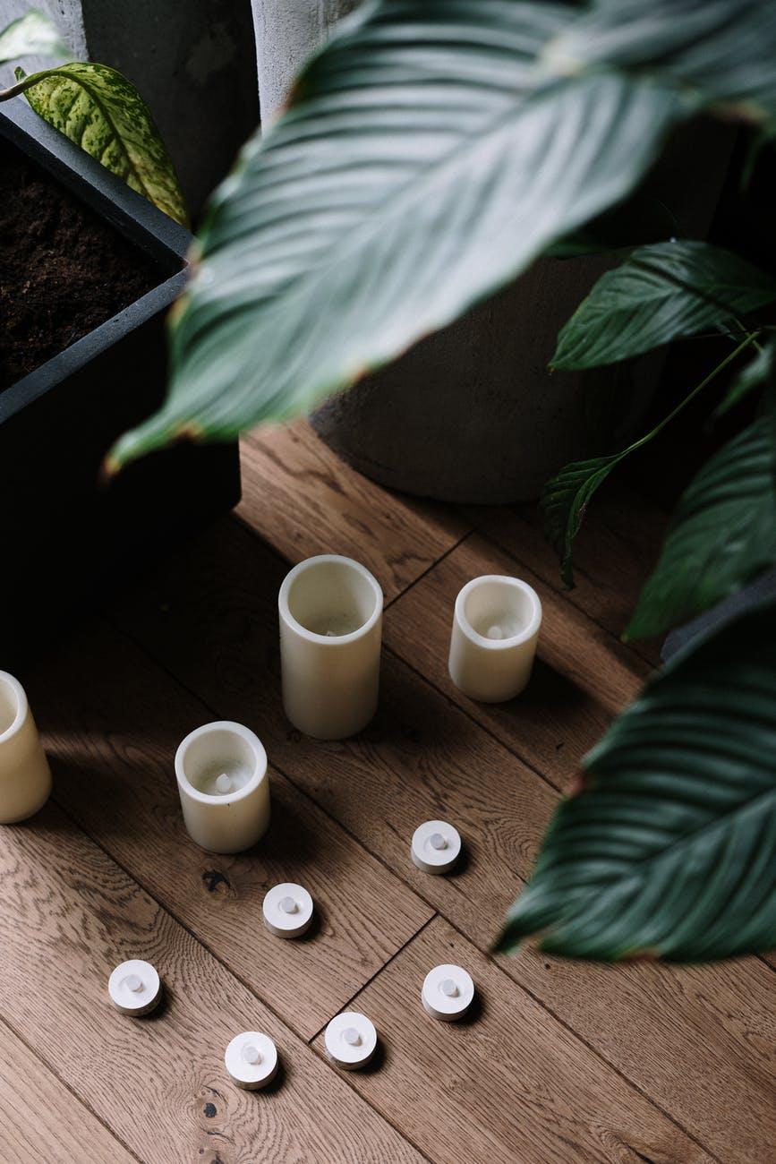 four white ceramic mugs on brown wooden table